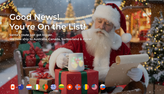 A festive illustration of Santa Claus next to his sleigh, holding a glowing PixelMug in one hand and a long list of new shipping destinations in the other, with flags of Australia, Canada, and European countries at the bottom.