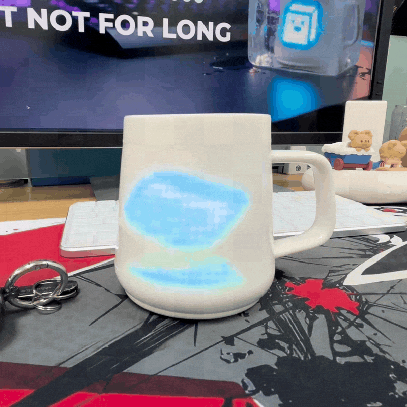 A dice rolling animation plays on a ceramic cup.