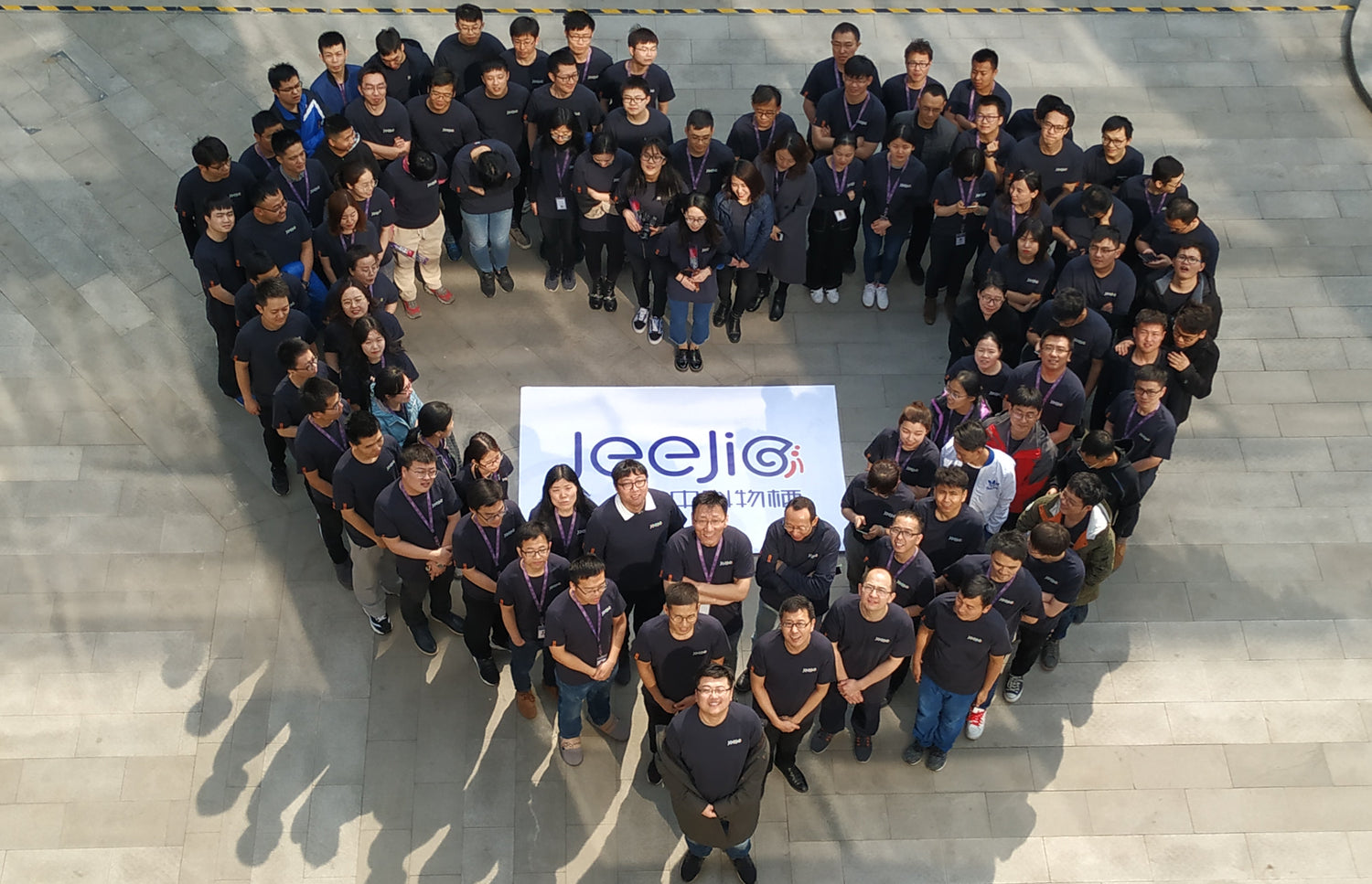 The Jeejio team gathered in a heart formation, representing the people and culture behind PixelMug