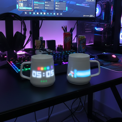 PixelMug P1 smart mugs with teal pixel display on a gaming desk setup with RGB keyboard and monitor.