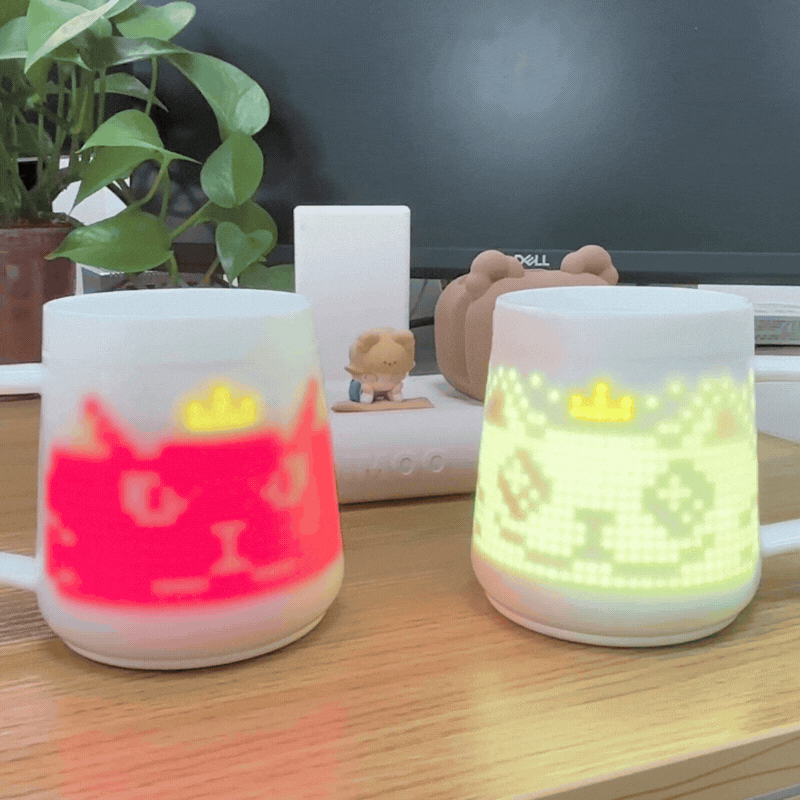 2 Pixel Mugs are displaying crowned cat animation on the desk